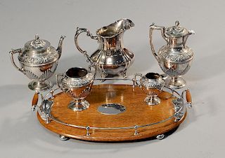 Edwardian four piece plated tea set with oak and silver plate handled galleried tray. Silver plate water pitcher accompanies