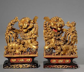 Pair of Chinese carved and gilt foo dogs