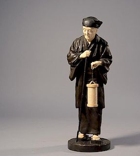 Fine Meiji period Japanese bronze and ivory figure of elderly gentleman carrying an ivory lantern