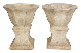 A Pair of Cast Stone Urns Height 15 1/2 inches.