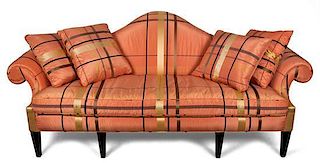 A George III Style Peach-Upholstered and Ebonized Camel-Back Sofa Height 34 1/2 x width 95 x depth 34 inches.