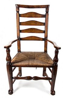 An American Oak Ladder Back Rush Seat Open Armchair Height 42 3/4 inches.