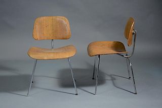 Pair of Eames design DCM chairs by Herman Miller with labels