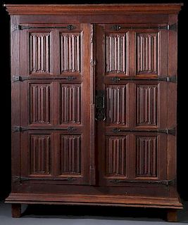 A FINE CARVED OAK “LINENFOLD” AND WROUGHT IRON