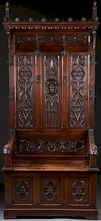 A NEO-GOTHIC  CARVED OAK HALL BENCH, 19TH CENTURY
