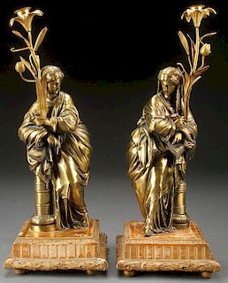 A PAIR OF AESTHETHIC FIGURAL BRONZE CANDLE STANDS