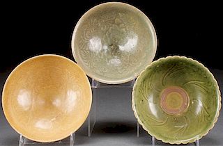 A GROUP OF THREE VIETNAMESE CARVED CELADON BOWLS