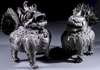 A LARGE PAIR OF CHINESE BRONZE “FOO DOG” CENSERS