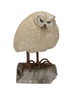 A cast stone owl with glass eyes