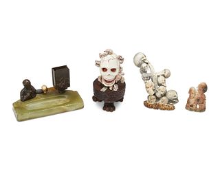 A group of carved bone skull figurines