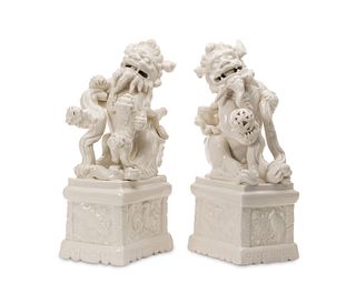 A pair of porcelain "Blanc de Chine" guardian lions
