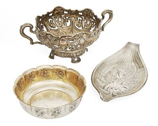 A group of silver table items