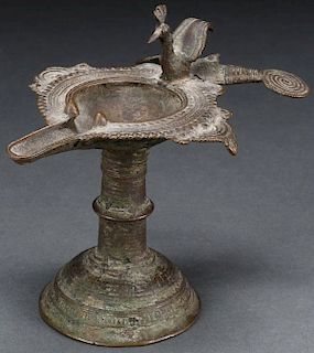 A BRONZE FOOTED OIL LAMP, PROBABLY BYZANTINE