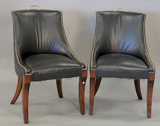 Pair of leather upholstered chairs.