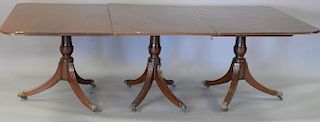 Mahogany triple pedestal dining table with two 13" leaves. ht. 28in. closed: 50" x 94", open: 50" x 120"