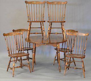 Seven piece lot including a Hitchcock round maple table with one 14" leaf and six fan back chairs. ht. 29in., dia. 42in.