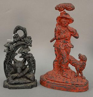 Two iron door stops including JZH 1949 fox hunt and a man with a dog. ht. 11in. & 15in.