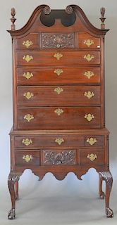 Chippendale style mahogany bonnet top highboy with shell and foliate carved center drawer fronts on ball and claw feet. ht. 7
