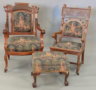 Three piece lot including two Victorian upholstered armchairs with carved backs and a ball and claw foot stool.
