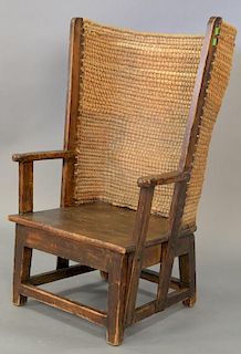 Small pine wing chair with woven rounded back.