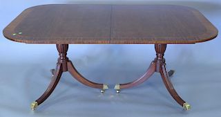 Custom mahogany dining table with banded inlaid top on double pedestal base having three 20" leaves. ht. 29 1/2in., top close