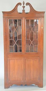 Pair of custom mahogany Chippendale style corner cabinets with broken arch tops. ht. 79in.