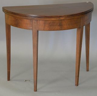 Mahogany Federal style demilune game table with line inlaid front and tapered legs. ht. 30in., lg. 36in.