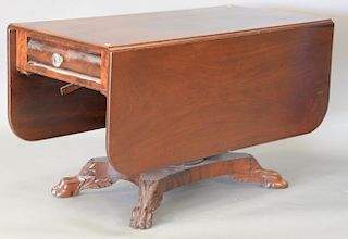 Large Victorian mahogany drop leaf table having one drawer on pedestal base with carved claw feet. ht. 28in., top: 23" x 48"