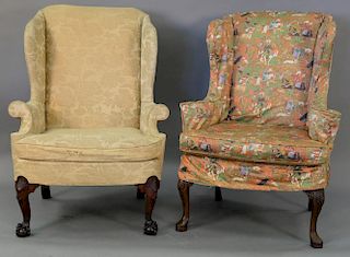 Two wing chairs including a wing chair with ball and claw feet and a wing chair with pad feet and carved shell knees.