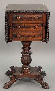 Federal style mahogany sewing stand having drop leaves over three drawers on carved pedestal base over four claw feet. ht. 30