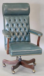 Executive swivel office chair with green leather upholstery (wear on arm rests).