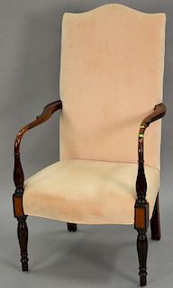 Custom Sheraton style lolling chair with carved arms over inlaid panel front over reeded and turned legs.