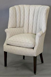 Contemporary upholstered barrel back armchair.