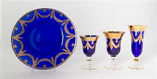 A Gilt Decorated Cobalt Glass Stemware Service, Diameter of charger 12 inches.