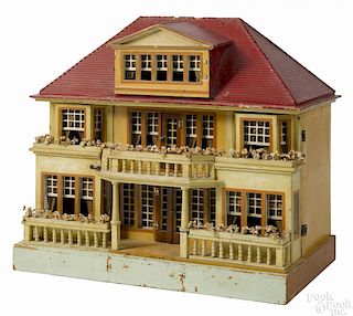 Gottschalk red roof doll house, with a split front opening, a dormer, floral topped balconies