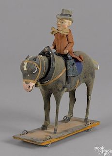 German composition and wood man riding a donkey pull toy, 7 1/2'' l.