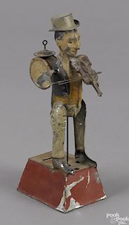 Gunthermann hand painted tin clockwork one-man band with a music box, 9 3/4'' h.