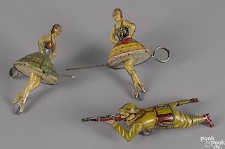 Pair of Marx tin lithograph ballerina tops, 5 1/2'' h., together with a Marx tin lithograph wind-up