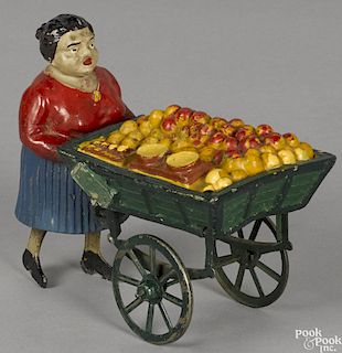French painted composition and tin clockwork lady orange cart vendor, 6 1/2'' h.