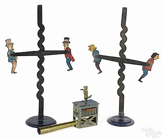 Tin toys, to include two seesaw gravity toys, one with Uncle Sam, 8'' h.