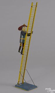 Marx tin lithograph wind-up climbing fireman, 22'' overall height.