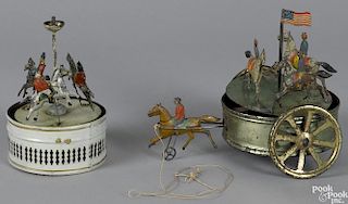 Two tin carousel toys, to include a horse drawn musical pull toy with horses and riders
