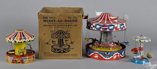 Three tin lithograph carousel toys, to include a Wolverine musical friction with its original box