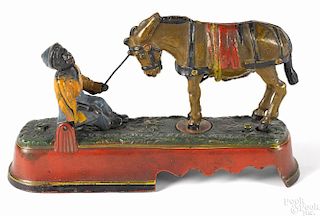 J. & E. Stevens cast iron Always did 'spise a mule mechanical bank with boy on bench, 6'' h.