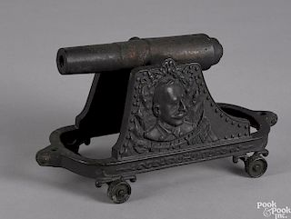 Cast iron Admiral Dewey cannon with a relief image on both sides, 11 3/4'' l.