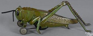 Hubley cast iron and aluminum grasshopper pull toy with articulated legs and clicker, 11 1/2'' l.