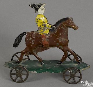 Early American painted tin horse platform toy with a lady riding side saddle, 4 1/4'' h., 4 1/2'' l.
