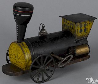 Stevens and Brown tin and wood clockwork train engine with a stenciled cab and front, 9 1/2'' l.