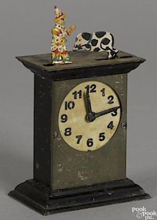 Animated painted tin clock penny toy, as the clock hands move, the clown waves his hand