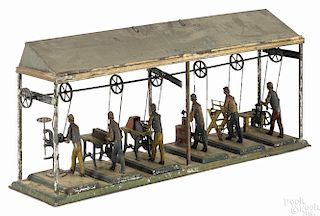 Unusual German painted tin steam toy workshop, probably Bing, having six workers under a canopy
